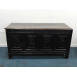 A carved oak quadruple panel coffer, 17th/18th century, the moulded top probably later, above a