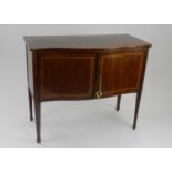 An Edwardian inlaid mahogany serpentine fronted sideboard, Williams of London, the top inlaid with