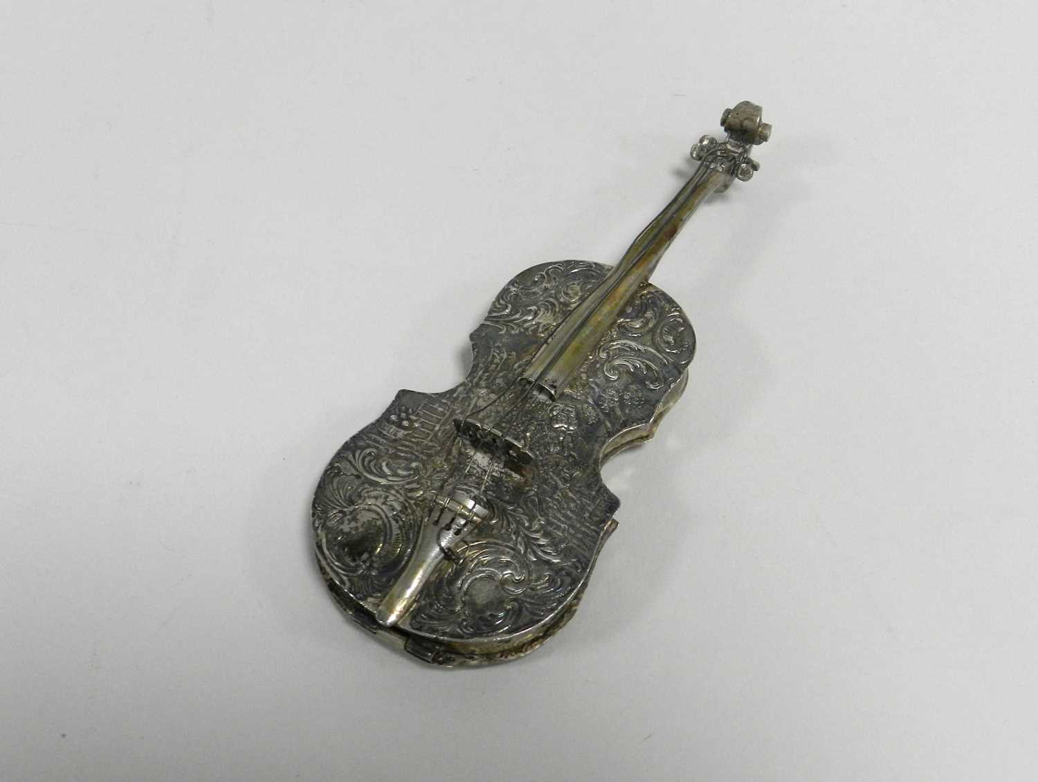 A 19th century Dutch white metal cello-form box