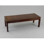 A Chinese rosewood low table, Kang, 20th century, of rectangular outline, 127cm long, 41cm high,
