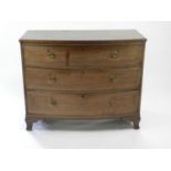 A 19th century mahogany veneered bowfronted chest of three long drawers, some damage and