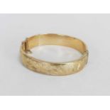 A 9ct gold hinged bangle