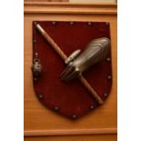 A reproduction decorative wall shield, mounted with a gauntlet clutching a mace, together with a