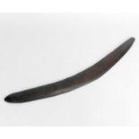 Australian Aboriginal tribal boomerang, Queensland, the dark grained wood carved with bands of
