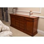 A Charles Barr burr walnut and mahogany veneered credenza-form sideboard, the frieze with central
