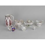 A group of English teapots, jugs and a miniature French jug