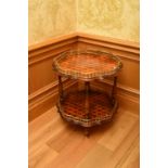 A reproduction parquetry and gilt-brass two-tier occasional table, of serpentine circular outline