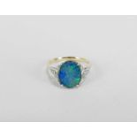 A single stone black opal doublet ring