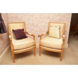 A pair of recent Clive Christian parcel gilt beech upholstered open armchairs, the padded back and