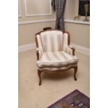 A pair of reproduction Louis XV style upholstered stained beech armchairs, the show wood with floral