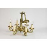 A Continental brass six-light chandelier, 20th century, the baluster stem issuing double-scroll