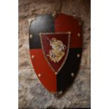 A reproduction painted wood armorial shield, decorated with St.George, together with three