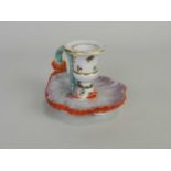 A Continental porcelain chamberstick, probably amateur decorated dated 1813 with dolphin-moulded