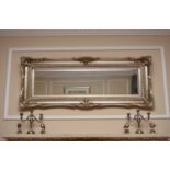 A reproduction silver coloured gesso foliate moulded rectangular wall mirror.150cm x 58cmFootnote: