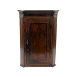 A George III oak and mahogany crossbanded and banded hanging corner cupboard