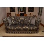 A recent reproduction Knoll sofa, with pinecone carved finials and covered in a damask style fabric,