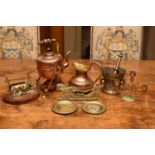 A group of copper and brasswares to include an arts and crafts style spirit kettle, a mortar and