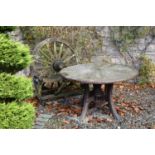 A teak wagon wheel backed rustic two-seater garden bench, 120cm wide, 60cm deep, 120cm high,