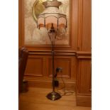 A reproduction antiqued-brass and cut glass standard lamp, with vase-form stem above a plain