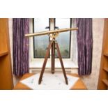 A reproduction brass telescope, with brass and teak adjustable tripod stand. 97cm long.Footnote: