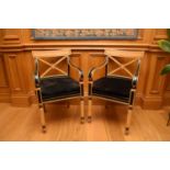 A pair of Clive Christian Empire style parcel-ebonised and parcel-gilt beech open armchairs, the top