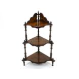 An Edwardian inlaid corner whatnot, the three shaped shelves supported by turned spindles, 87cm