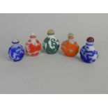 Six Chinese cameo glass snuff bottles, 20th century, each of ovoid form and worked with dragons,