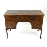 A 20th century, George II style, walnut veneered writing table, converted from a dressing table