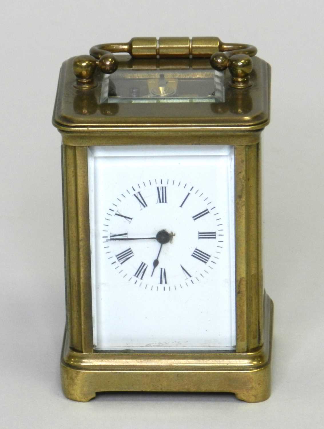 An early 20th century miniature carriage timepiece, obis case and with a 1.75” enamelled dial, an