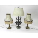 A bronze and marble table lamp and a further pair of lamps