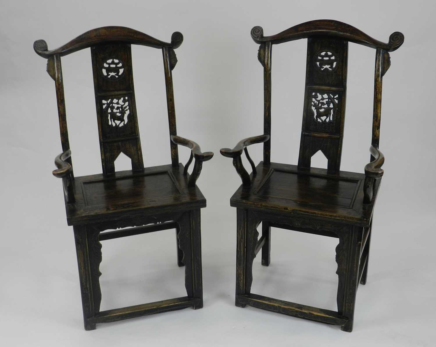 A pair of Chinese softwood armchairs, 20th century, possibly cedar wood, of yoke back form with