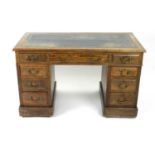 A circa 1900 oak twin pedestal desk