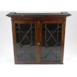 An inlaid mahogany glazed bookcase top, the ogee cornice above astragal glazed doors opening to
