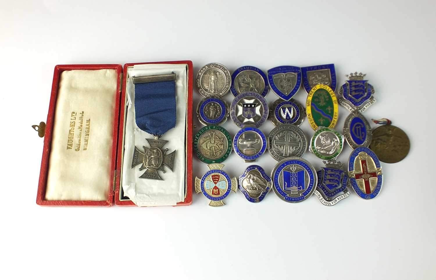 A collection of sixty-three silver and enamelled nursing medals