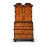 A Queen Anne/George I figured walnut bureau bookcase