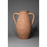 A twin handled pottery jar, possibly 1st-2nd century A.D.