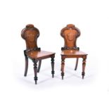 A pair of Regency mahogany hall chairs