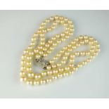 A two strand graduated cultured pearl necklace with diamond set clasp