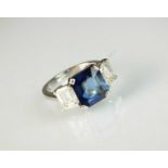 An 18ct white gold three stone sapphire and diamond ring