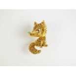 An 18ct gold turquoise and sapphire novelty brooch in the form of a fox