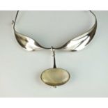 A Georg Jensen silver neck ring and rutilated quartz pendant designed by Vivianna Torun Bulow-Hube