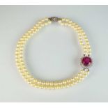 A pink tourmaline and diamond cluster on two strand cultured pearl necklace