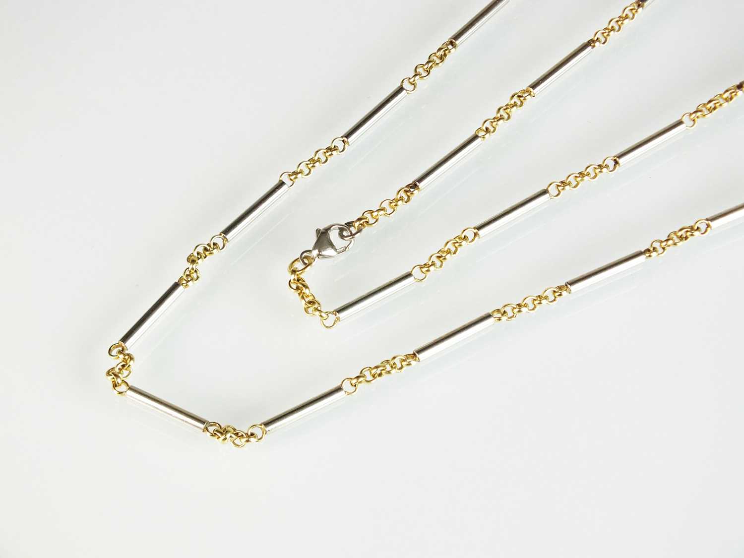 A platinum and yellow metal chain necklace