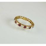 An 18ct gold ruby and diamond full eternity ring by Boucheron