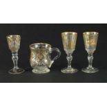 Three 18th century gilded drinking glasses and a mug