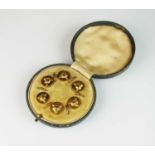 A cased set of six fox mask dress studs