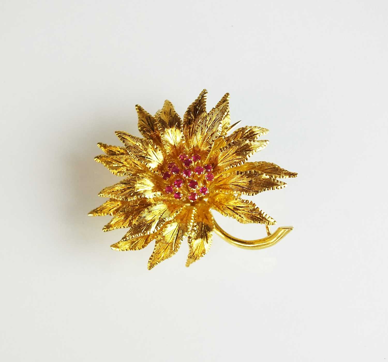 An 18ct gold ruby set flower brooch