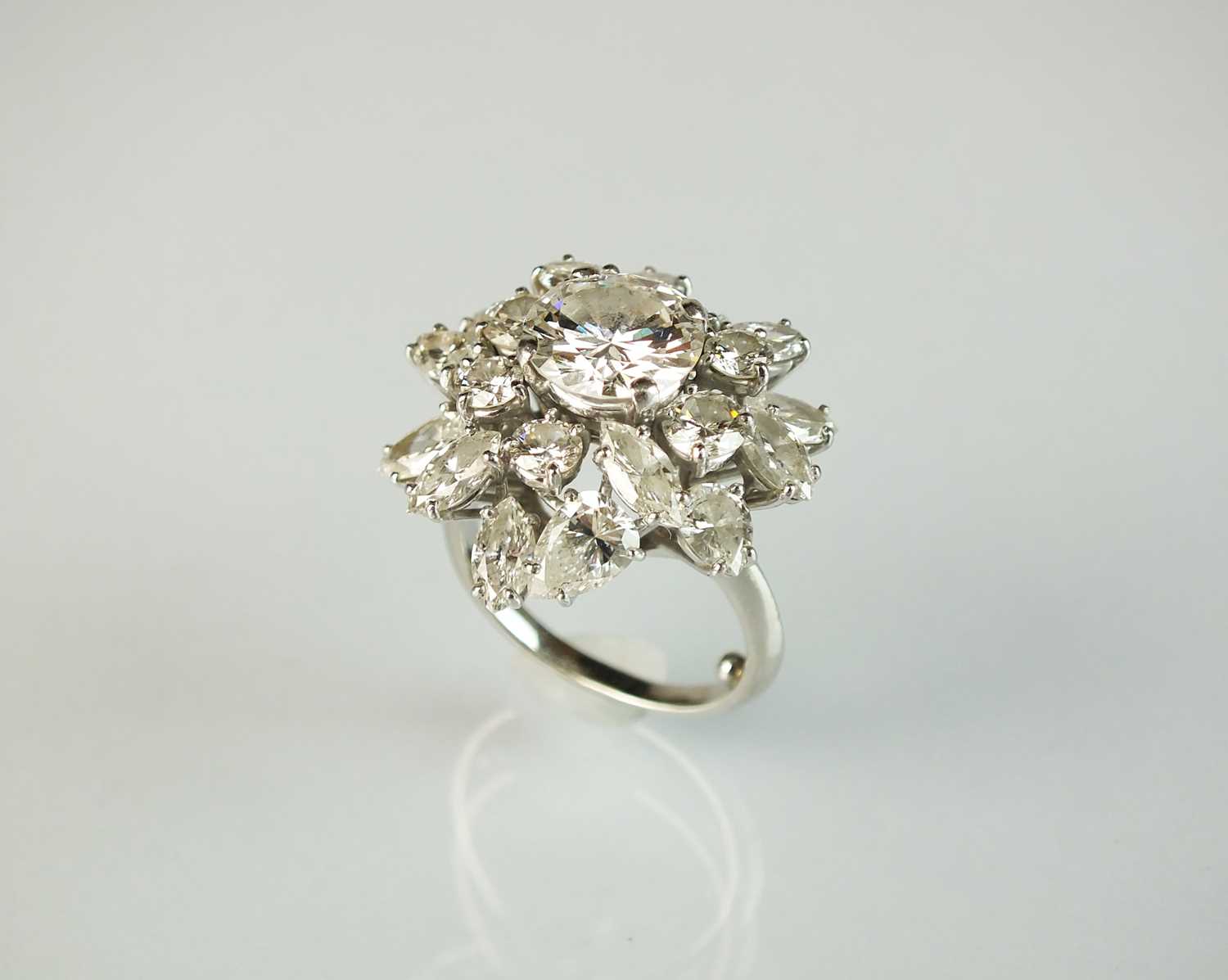 An impressive diamond cluster ring by Boucheron, designed as a central brilliant cut diamond claw