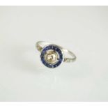 An Art Deco diamond and sapphire target ring, designed as a central old cut diamond collet set