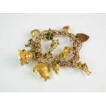 A 9ct gold bracelet with attached charms